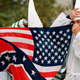 Three members of the Ku Klux Klan hide behind a combination Confederate and American flag Oct. 23, 1999, in New York.
DOUG KANTER/AFP/Getty Images